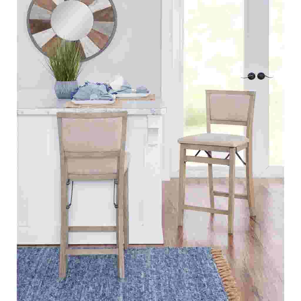 Two grey wash folding counter stools in a kitchen setting