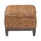 Side view of square handwoven seagrass storage ottoman with dark legs