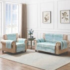 Multiple light blue quilted furniture protectors on chairs