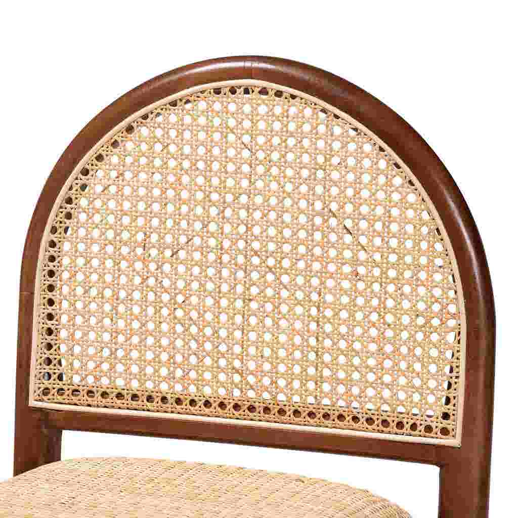 A close-up of the woven cane back of a wooden counter stool.