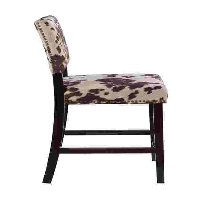 Side view of Cypress counter stool with cowhide pattern upholstery and dark wood frame