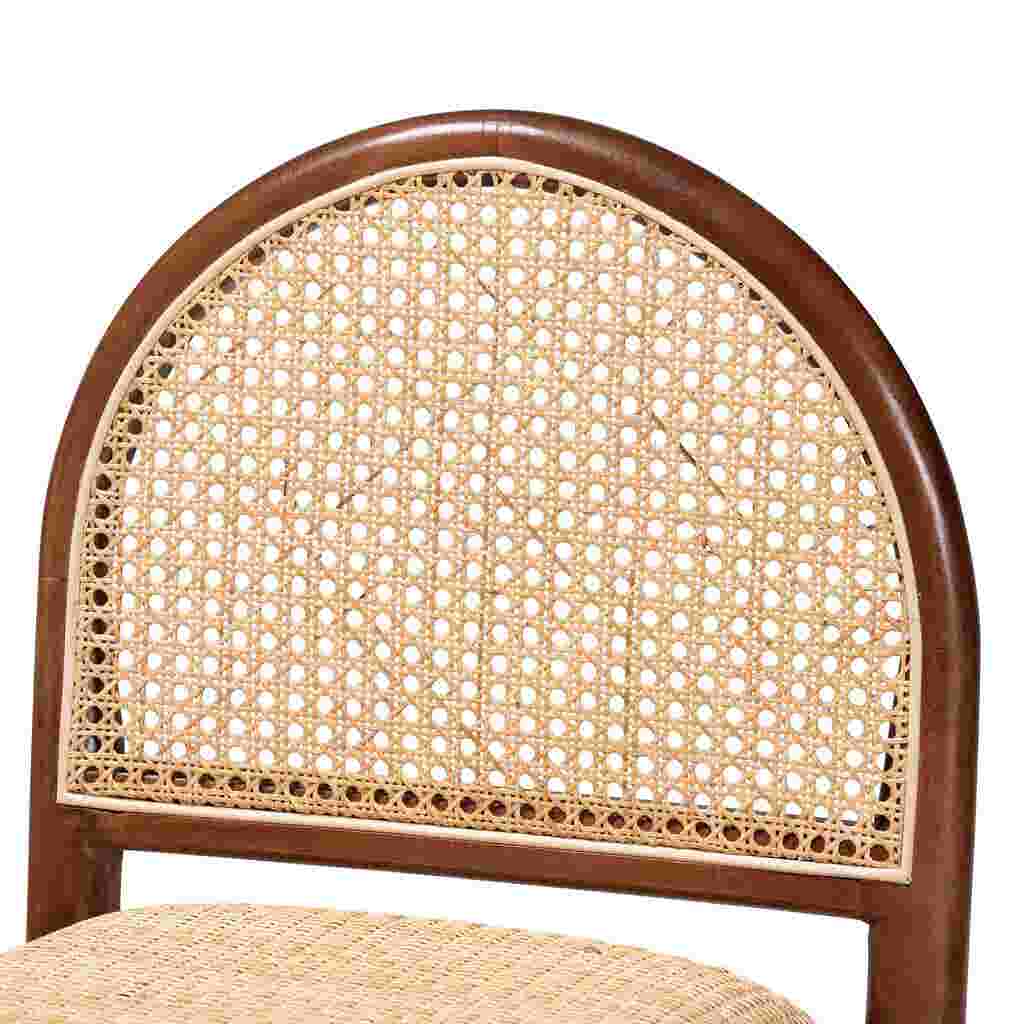 A close-up of the woven cane back of a wooden counter stool.