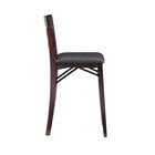 Close-up side view of a dark wood bar stool with cushioned seat.
