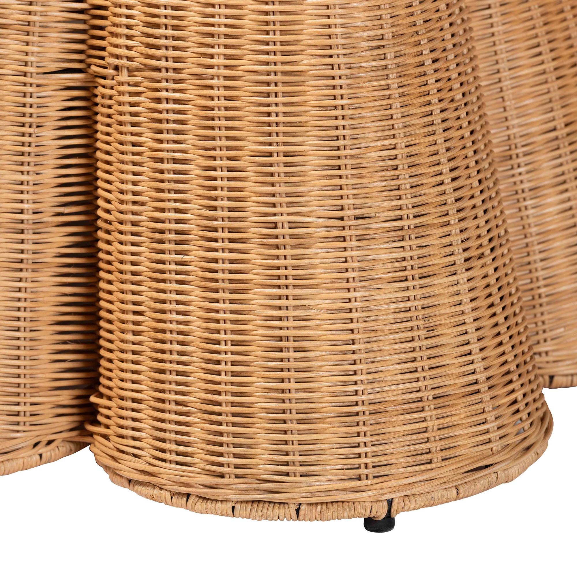 Close-up of woven rattan texture on scalloped ottoman base