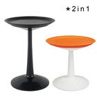 Black round pedestal side table and an orange one side by side