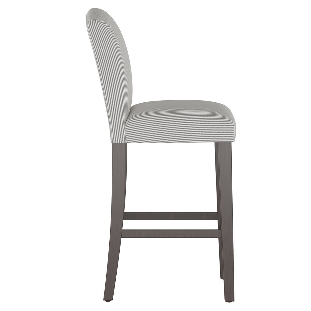 Side view of a stripe camelback barstool with gray and white striped upholstery and dark wood legs