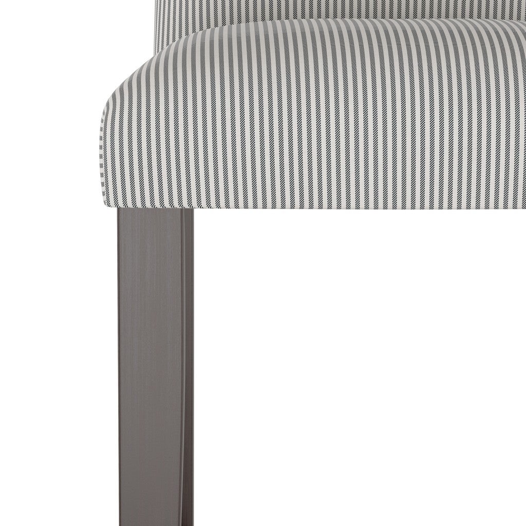 Close-up of the seat and leg of a stripe camelback barstool with gray and white striped upholstery