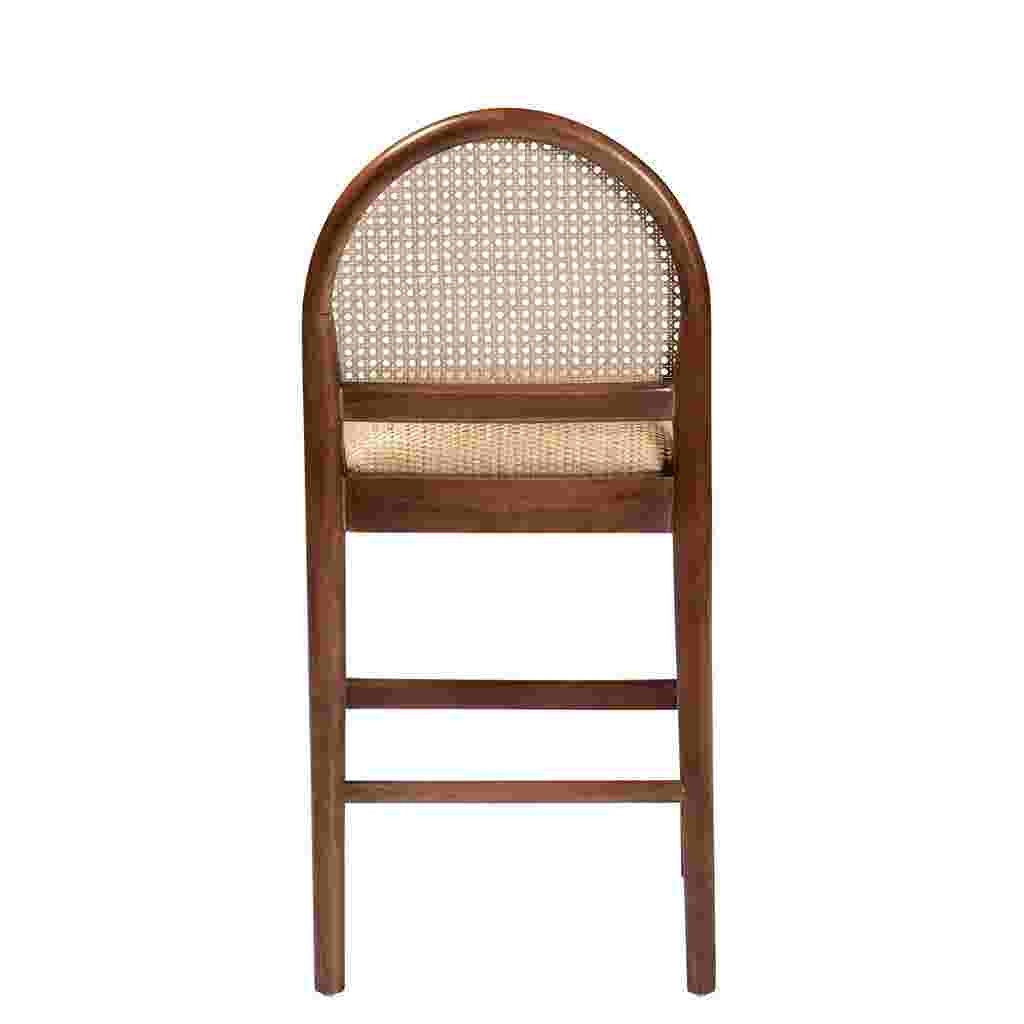 A front view of a wooden counter stool with a woven cane back and seat.