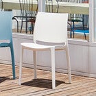 White stackable outdoor dining chair angled view