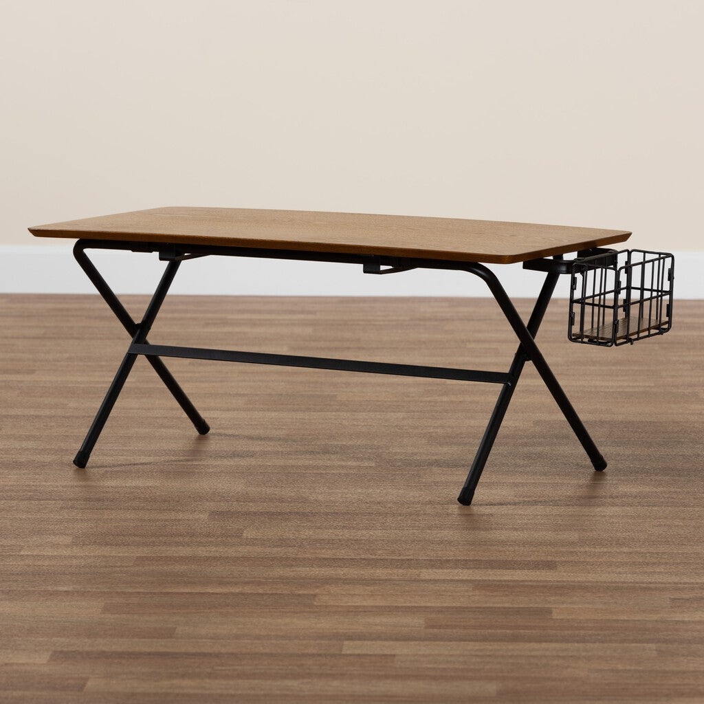 Rectangular coffee table with natural brown wood top and black metal frame, featuring a wire basket on the side, placed on a wooden floor.