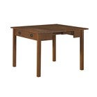 Corner view of expanding wooden table with drawers