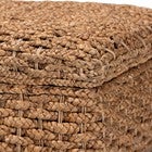 Close-up of woven seagrass texture on square storage ottoman lid