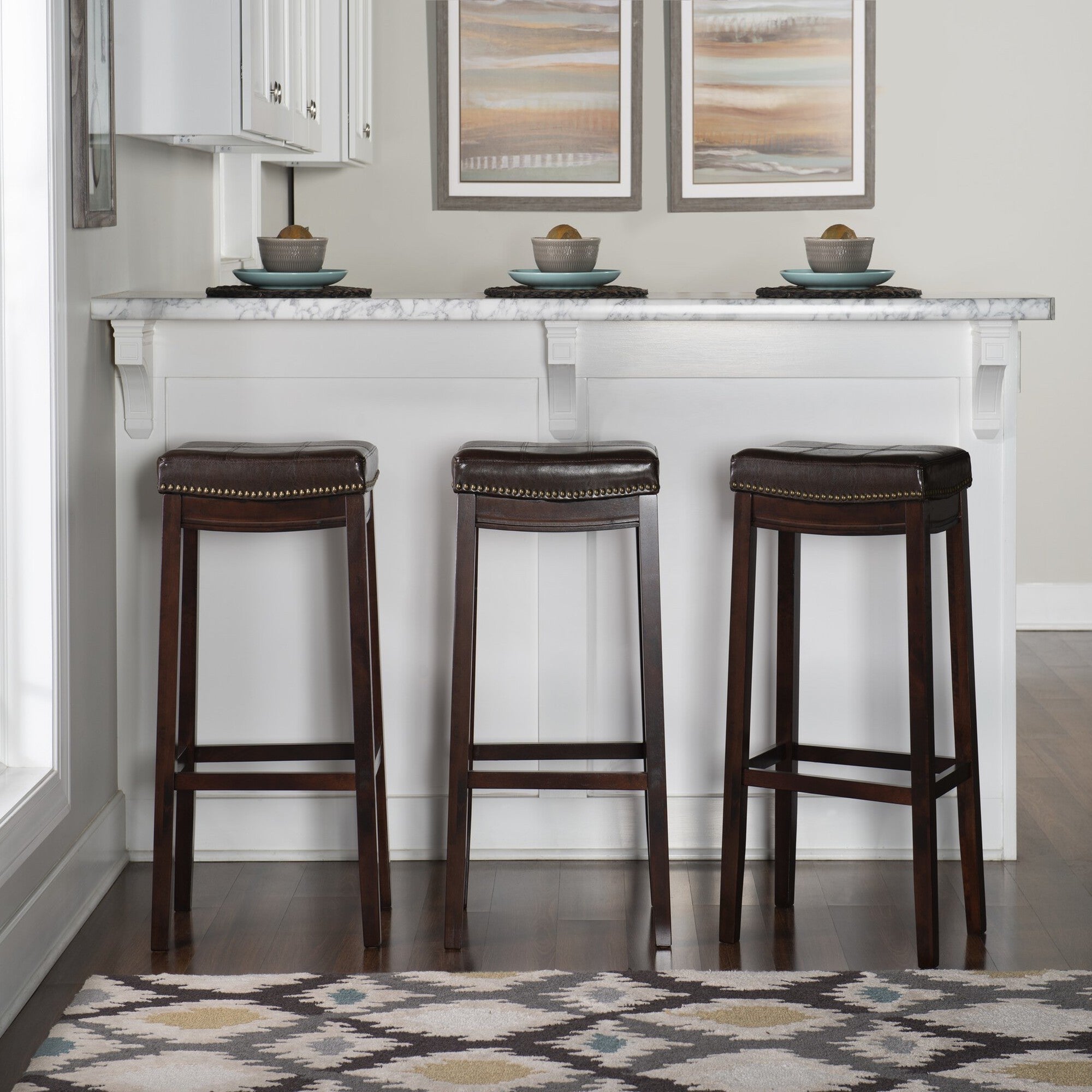 Set of three Crowell brown bar stools with dark leather-look seats and nailhead trim