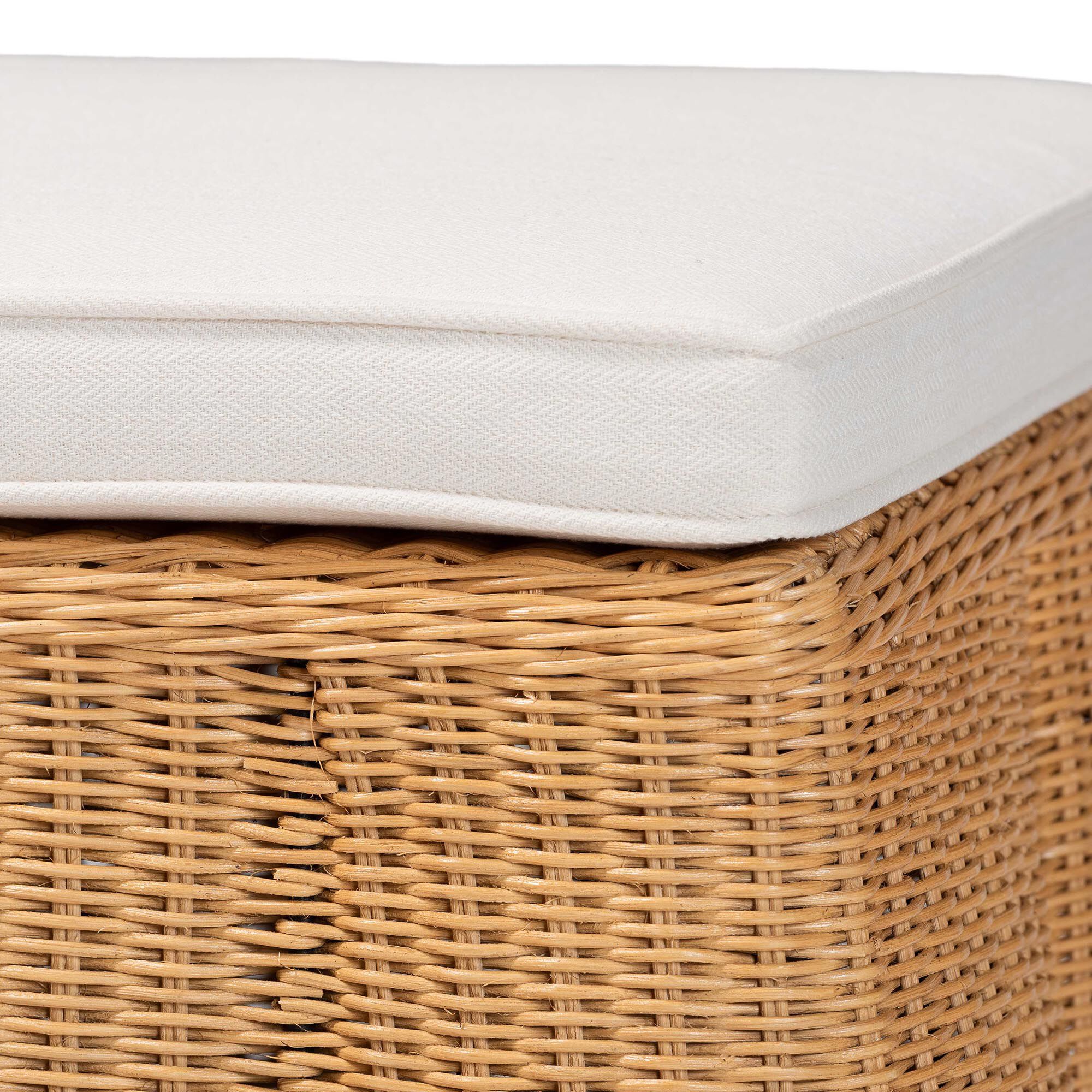 Close-up of white cushion on natural rattan ottoman