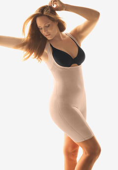 Foto de Plus size woman in beige underclothes pulling shapewear