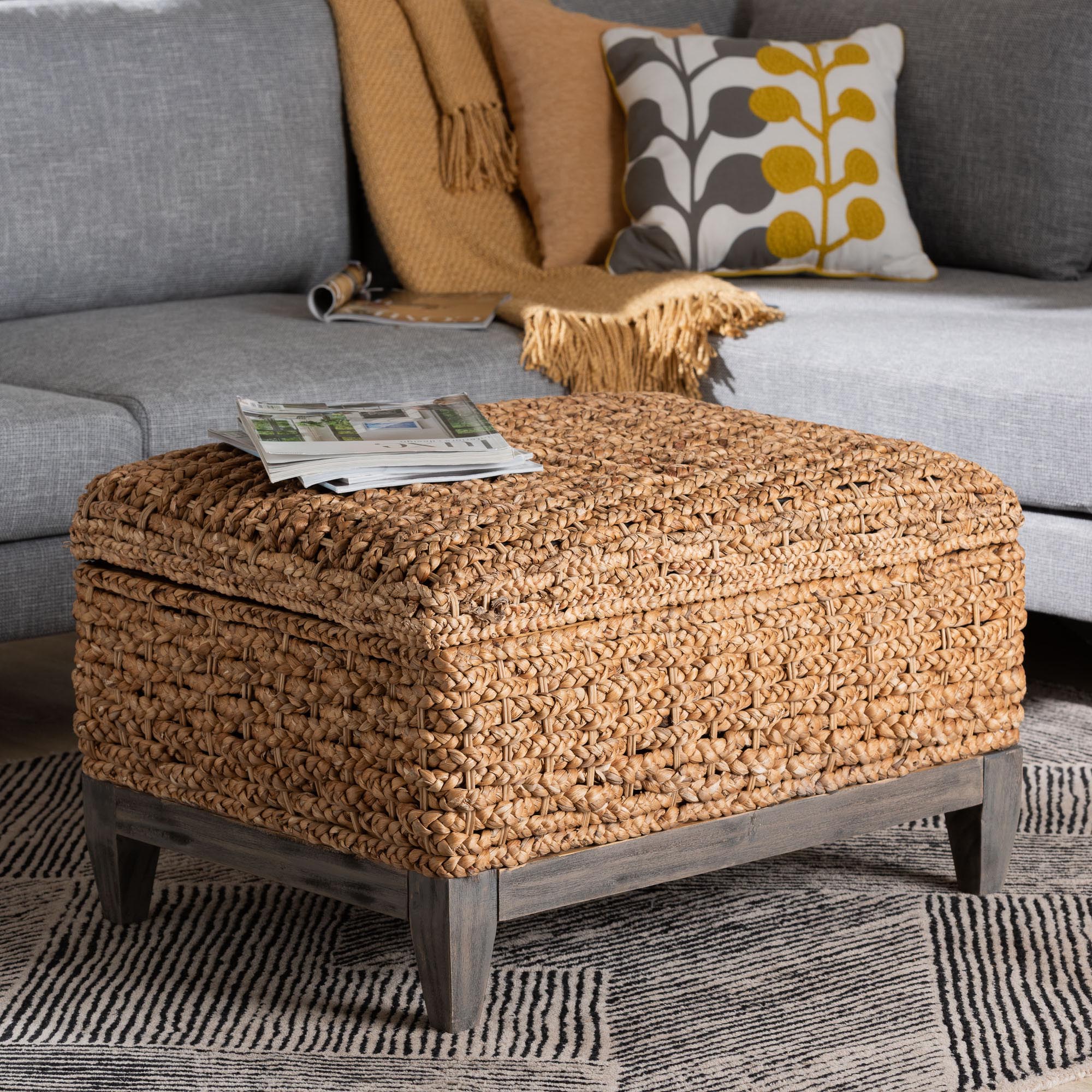 Square handwoven seagrass storage ottoman with cushioned top and dark legs